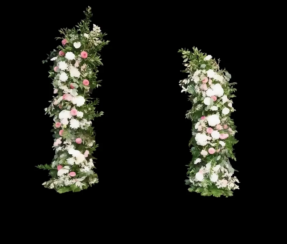 Floral archway with white and pink roses, greenery on black background.