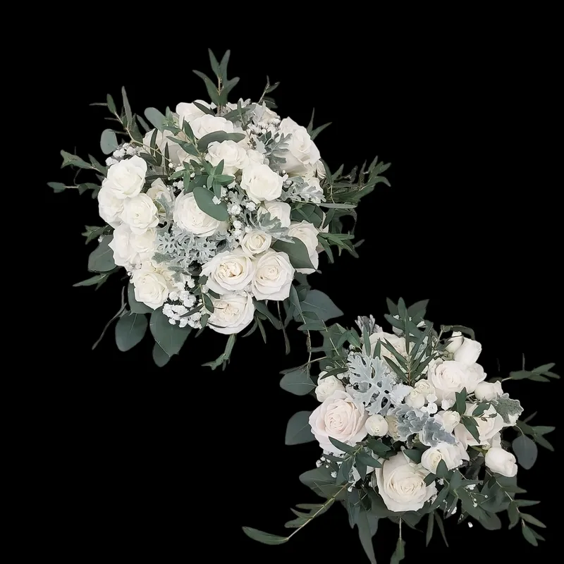 Two white floral bouquets with green foliage.