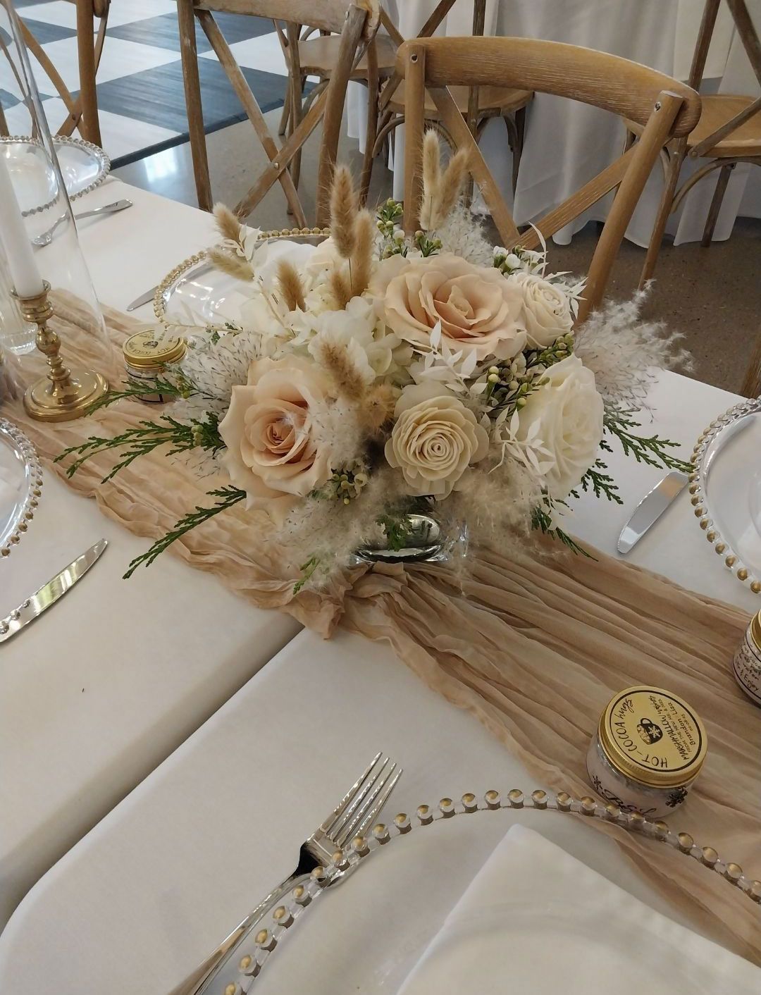Table setting with floral centerpiece and gold accents.