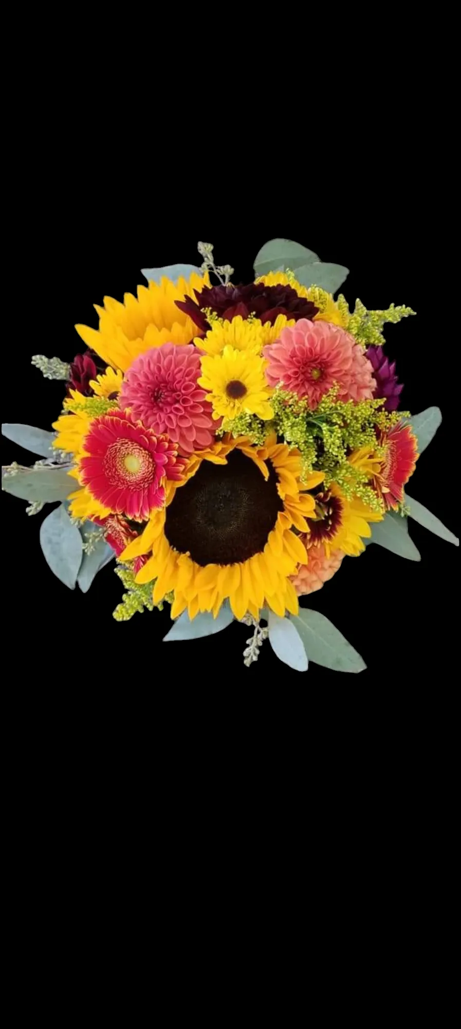 Close-up of a bouquet with sunflowers, pink and yellow flowers, and green leaves against a black background.