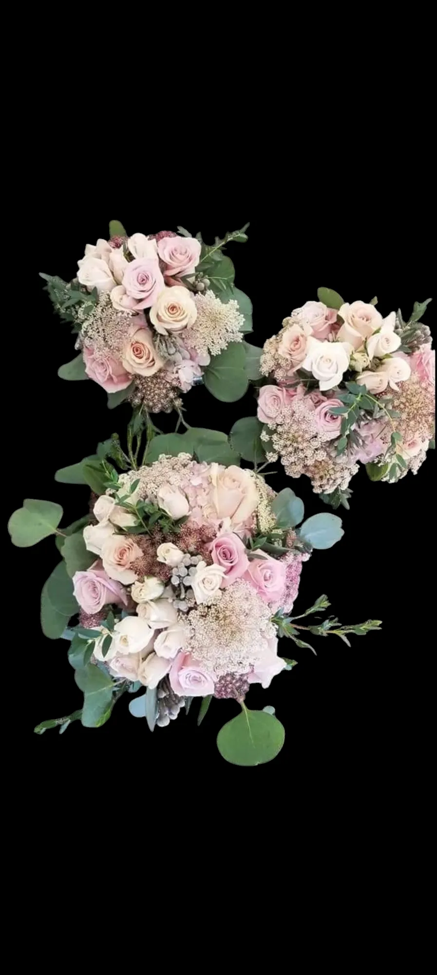 Three bouquets with pink, peach, and cream flowers against a black background.