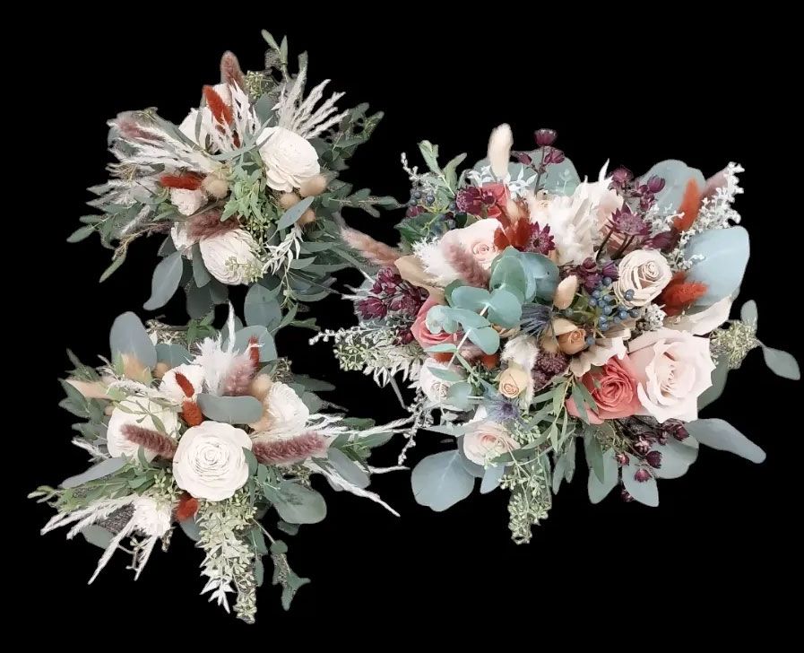 Three wedding bouquets with roses, eucalyptus, and dried grasses on a black background.