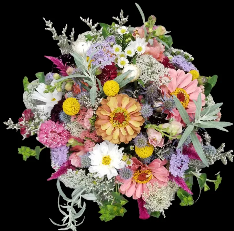 Colorful bouquet of various flowers with black background.