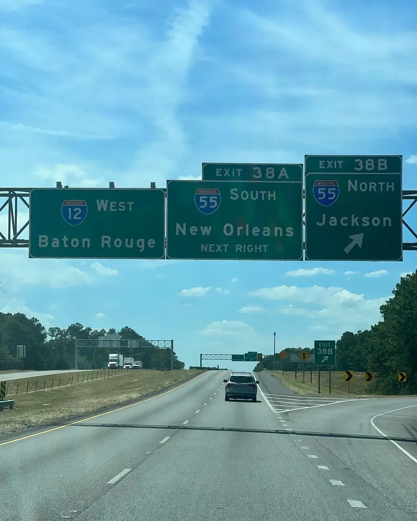 Highway signs for I-12 West to Baton Rouge and I-55 South to New Orleans, and I-55 North to Jackson.