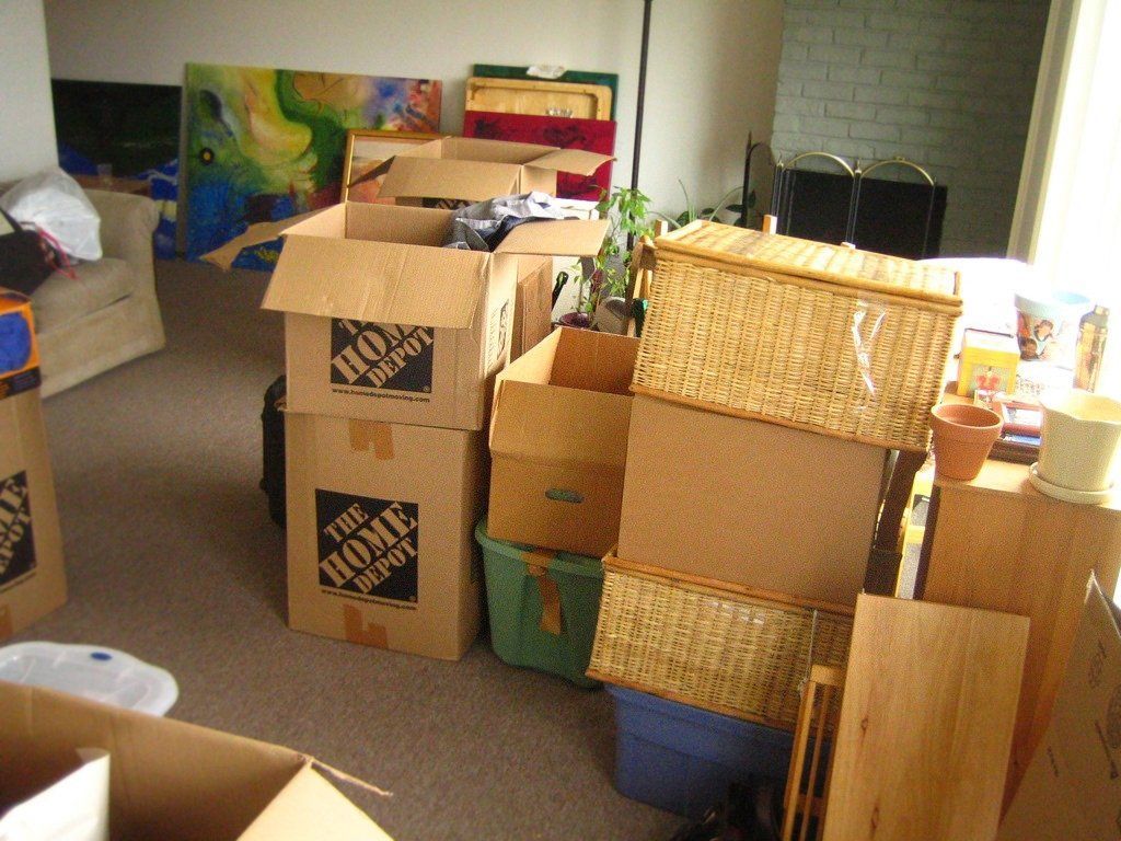 Boxes and household items in a room, indicating a move.