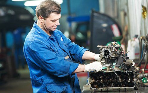 Mechanic Reparing car engine