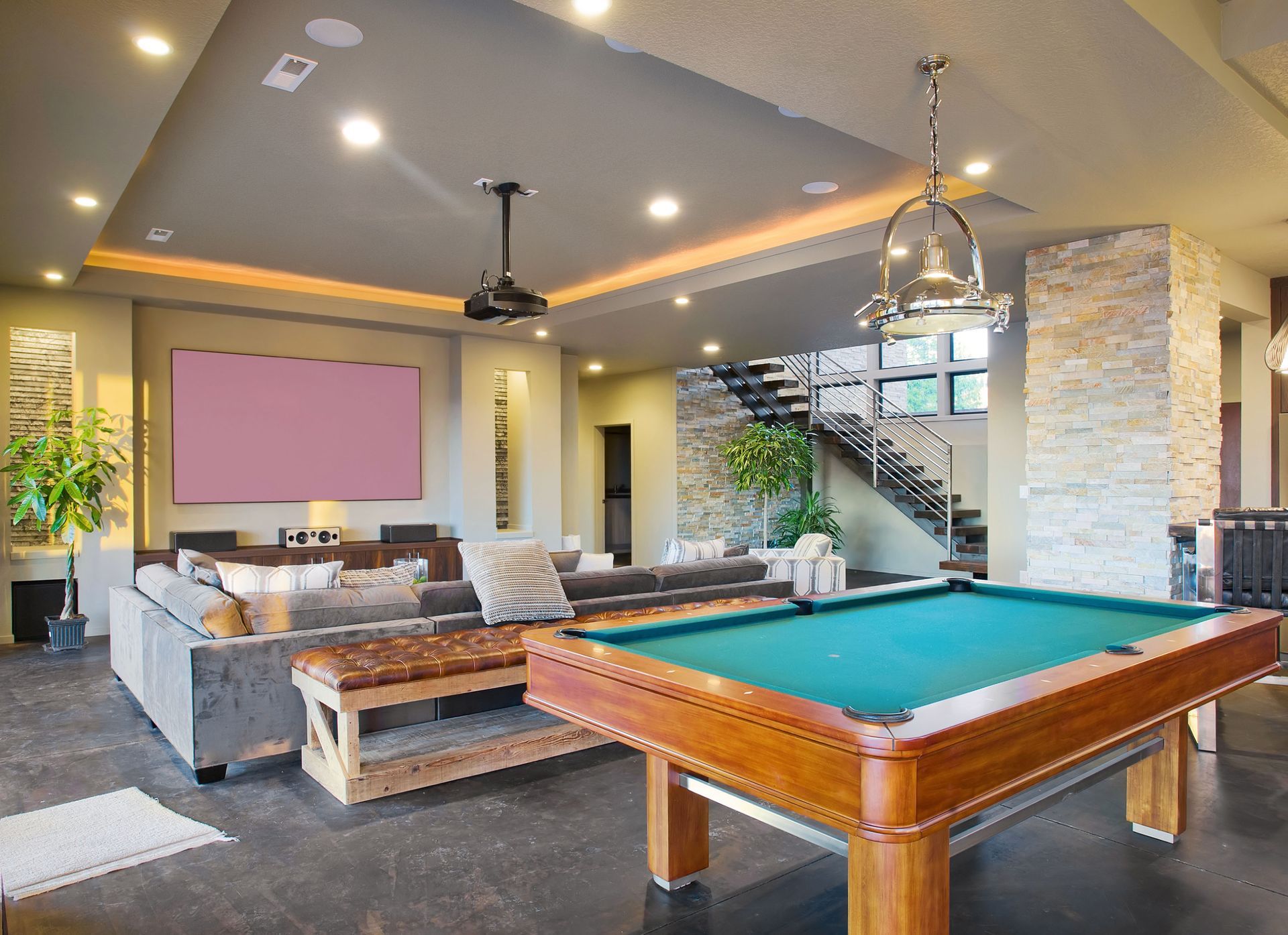 Game room with pool table, large screen, and seating area.