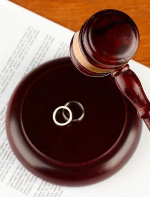 Gavel, couple ring and divorce paper