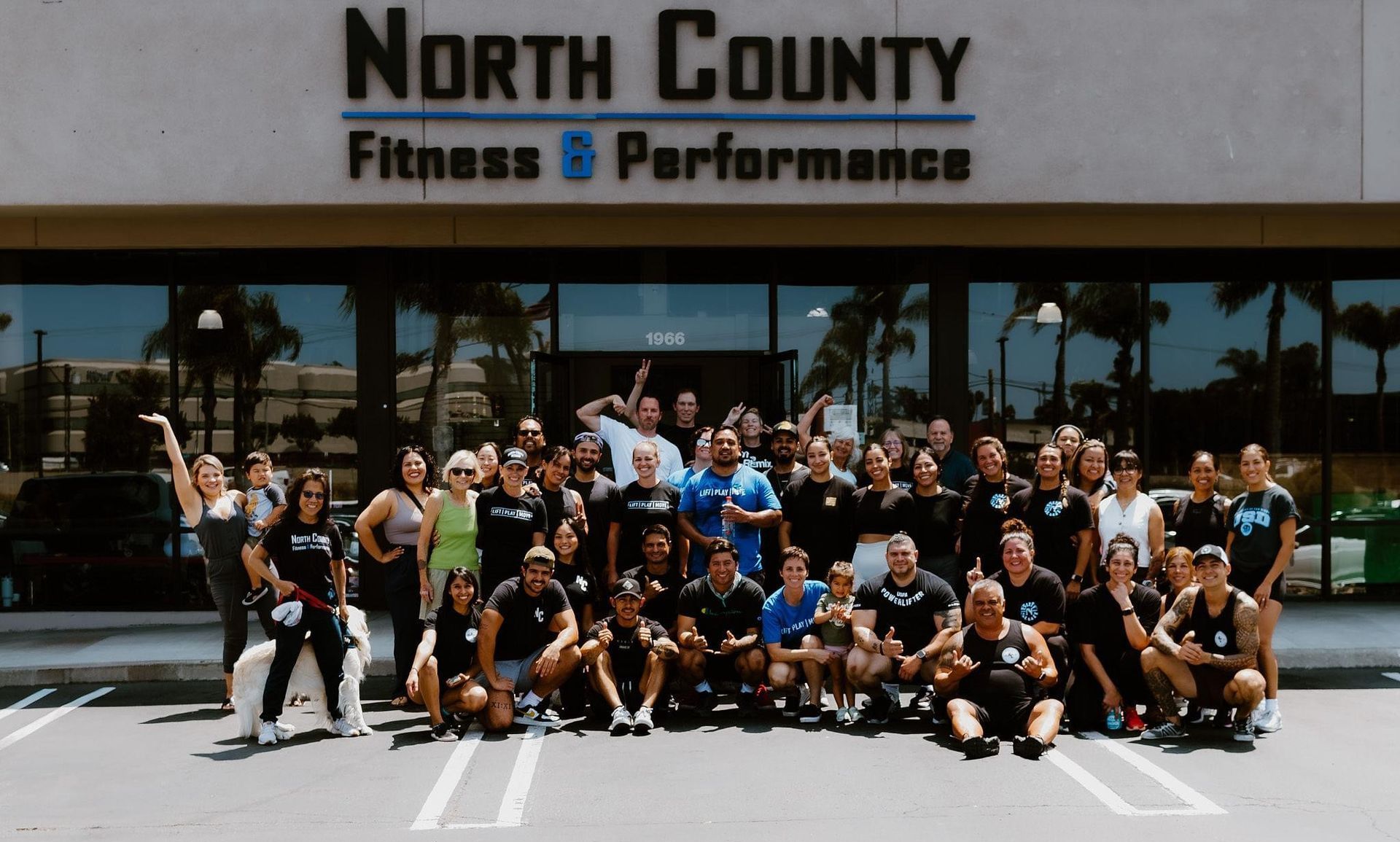 A group of people are riding exercise bikes in a gym that says north county fitness & performance