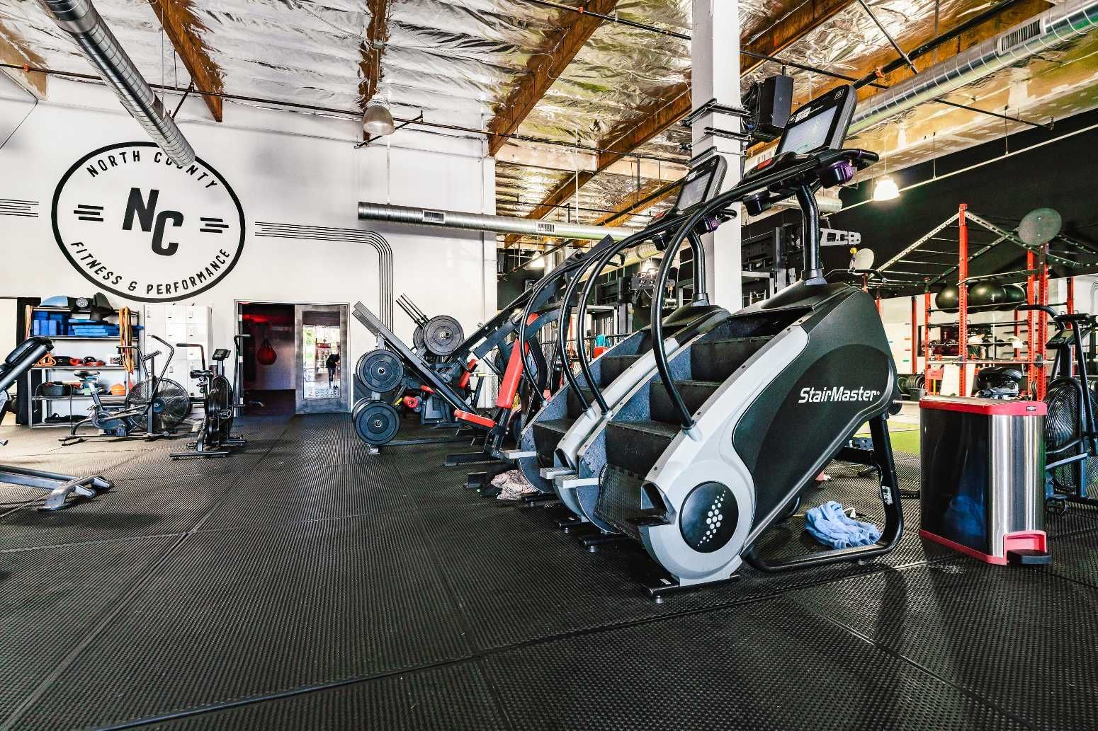 A gym filled with lots of exercise equipment and a sign that says nc.