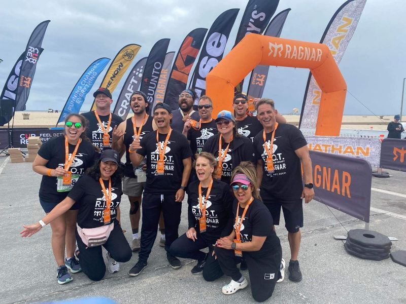 A group of people posing for a picture in front of a banner that says 57 ragnar