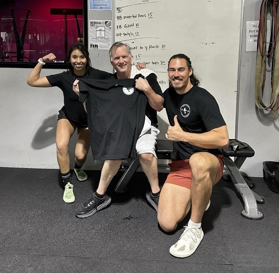 A group of people posing for a picture in a gym