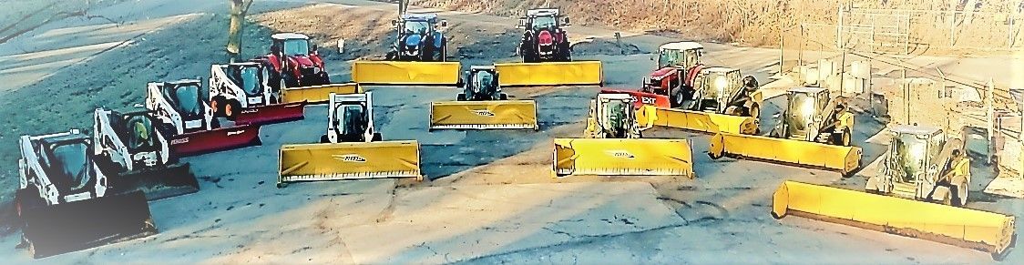 Several bulldozers and tractors with yellow blades on a construction site