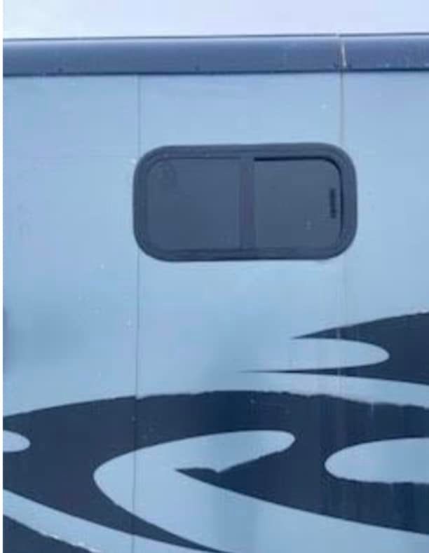 A close up of a window on the side of a truck.