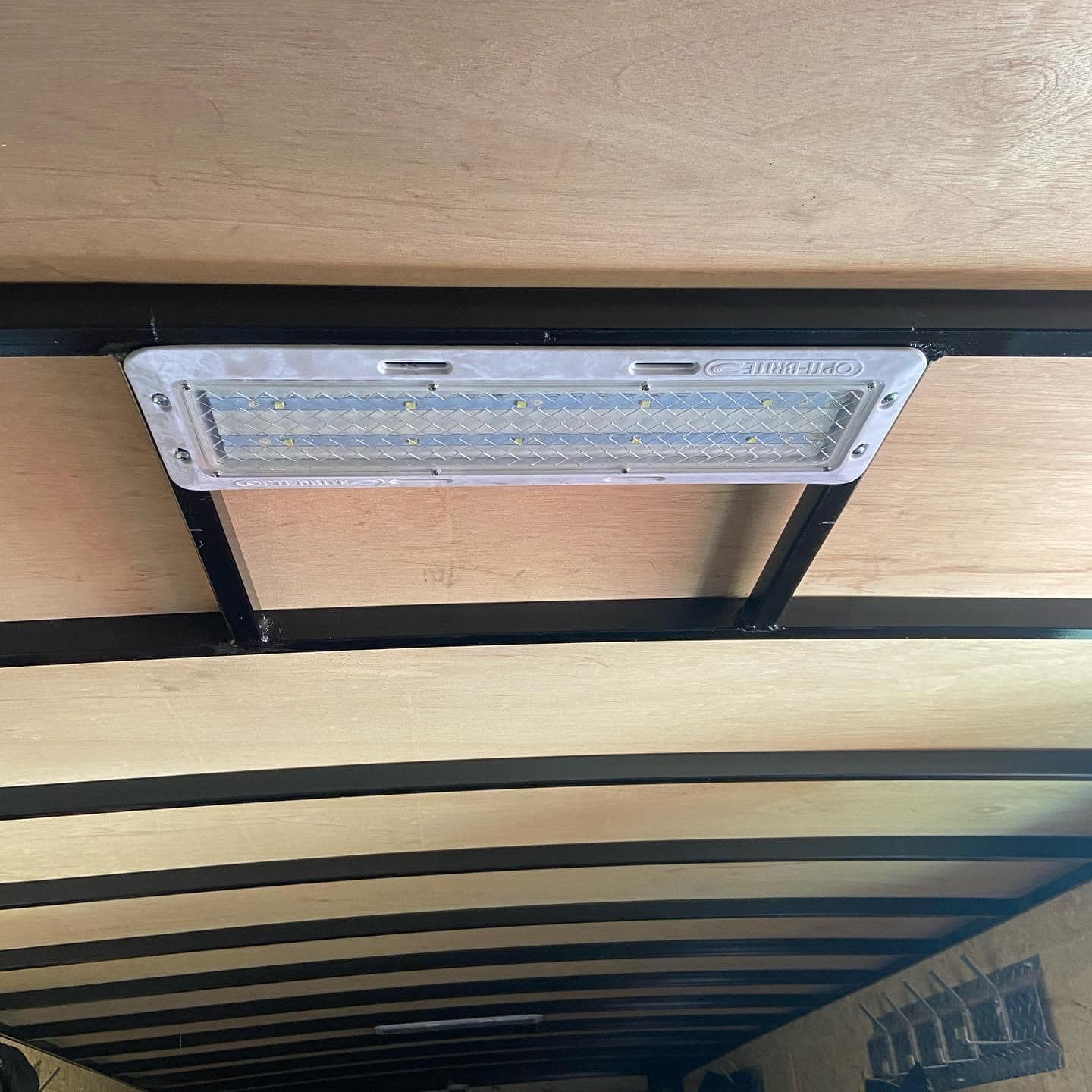 A light is hanging from the ceiling of a trailer.