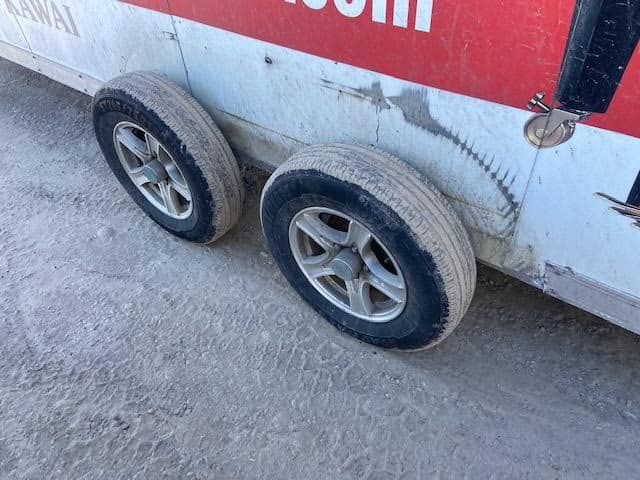 A red and white trailer with the word kuwait on it