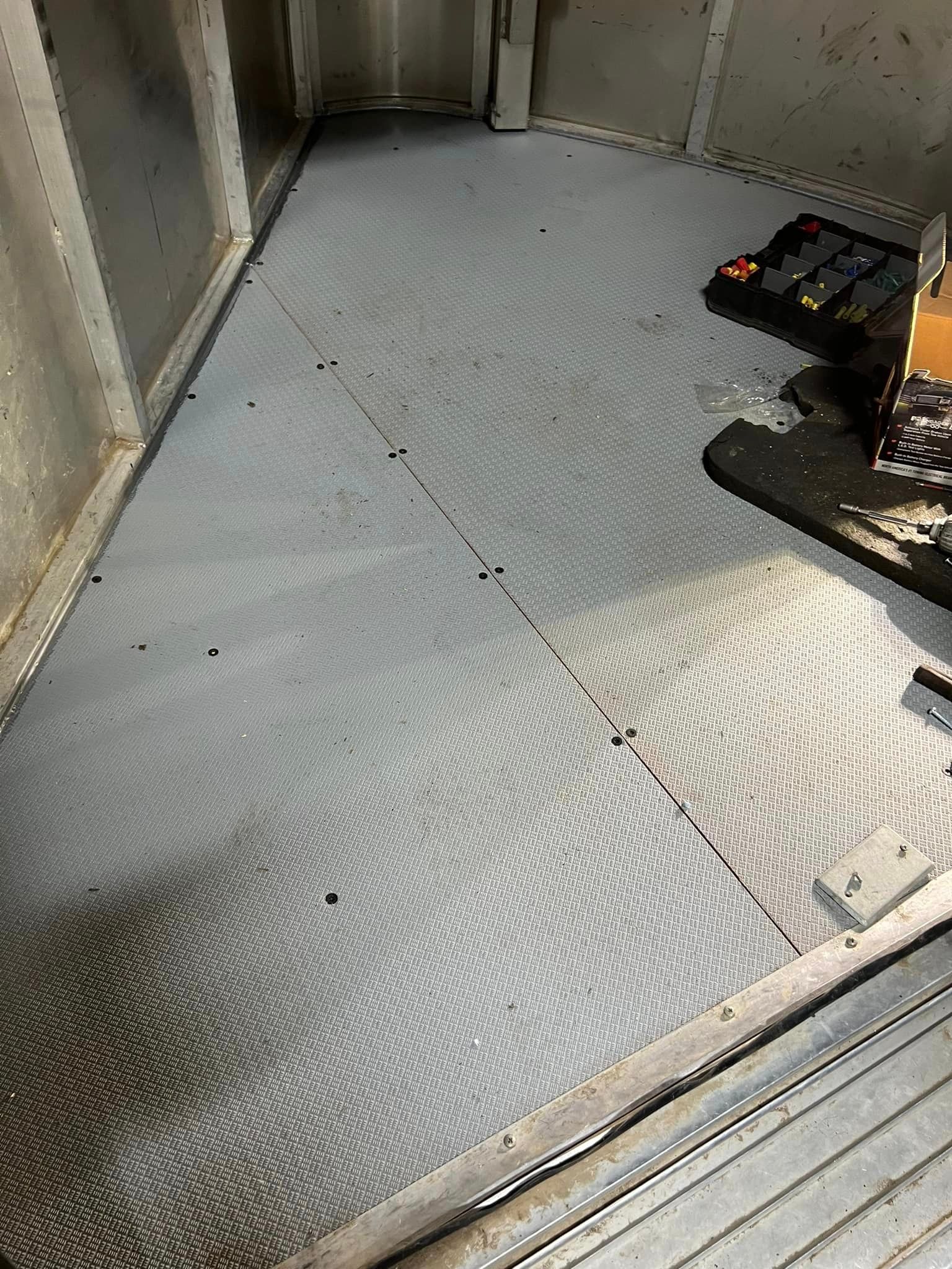 A close up of a metal floor in a room.
