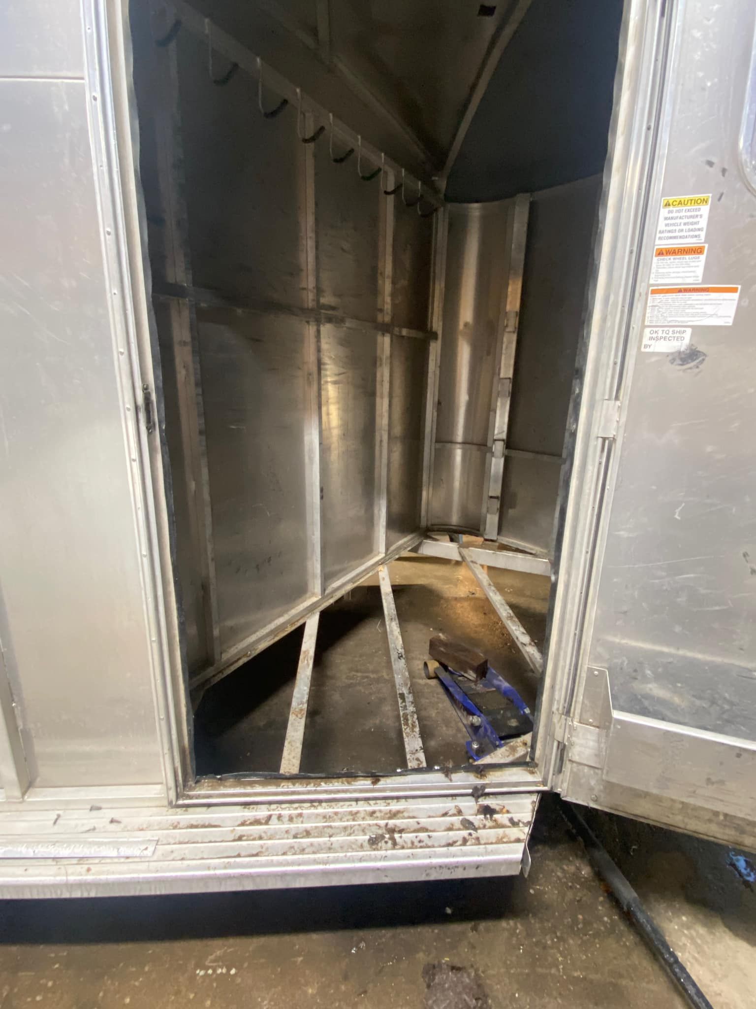 The inside of a metal container with the door open.