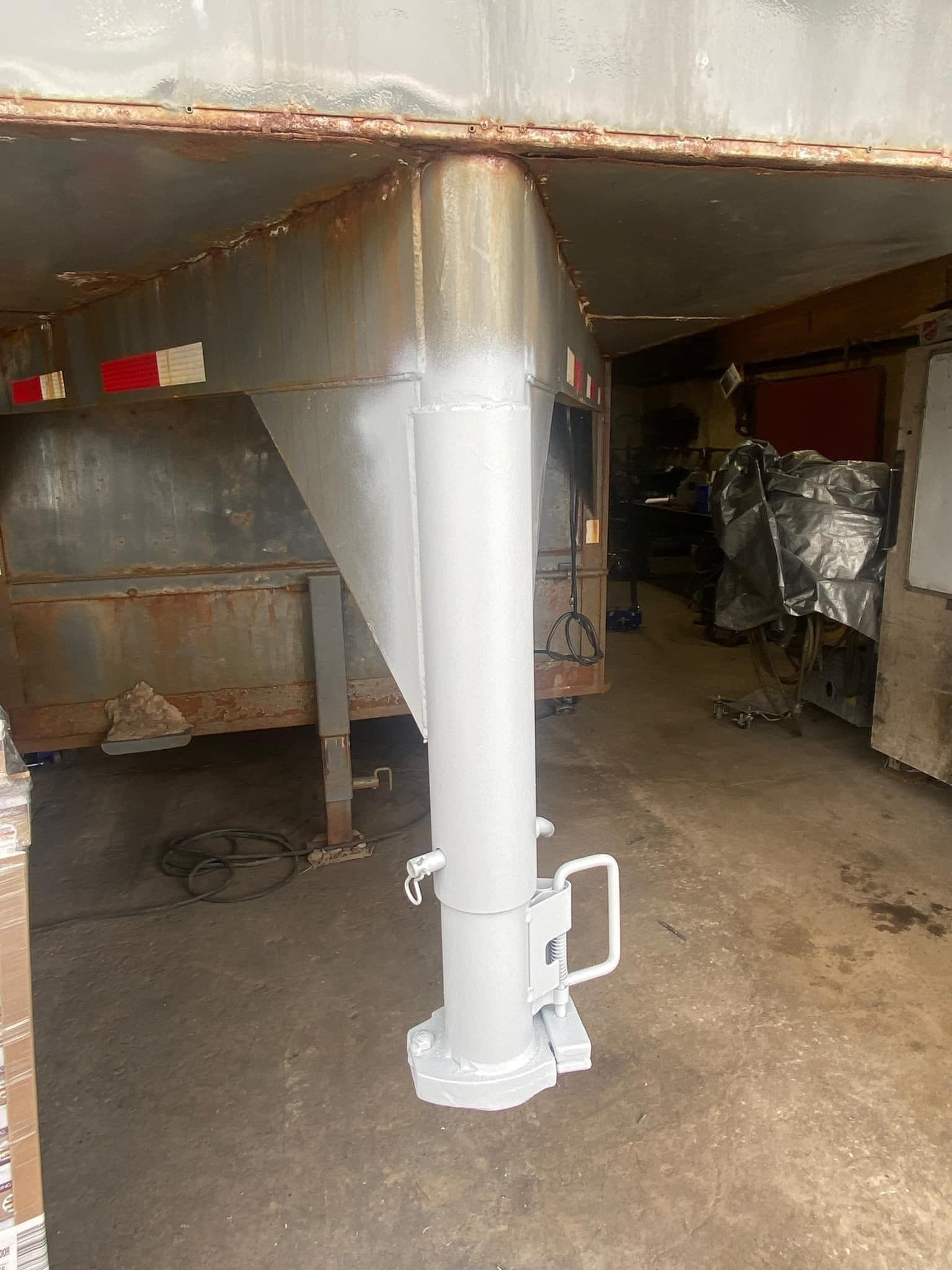 A white pole is sitting in the middle of a garage.