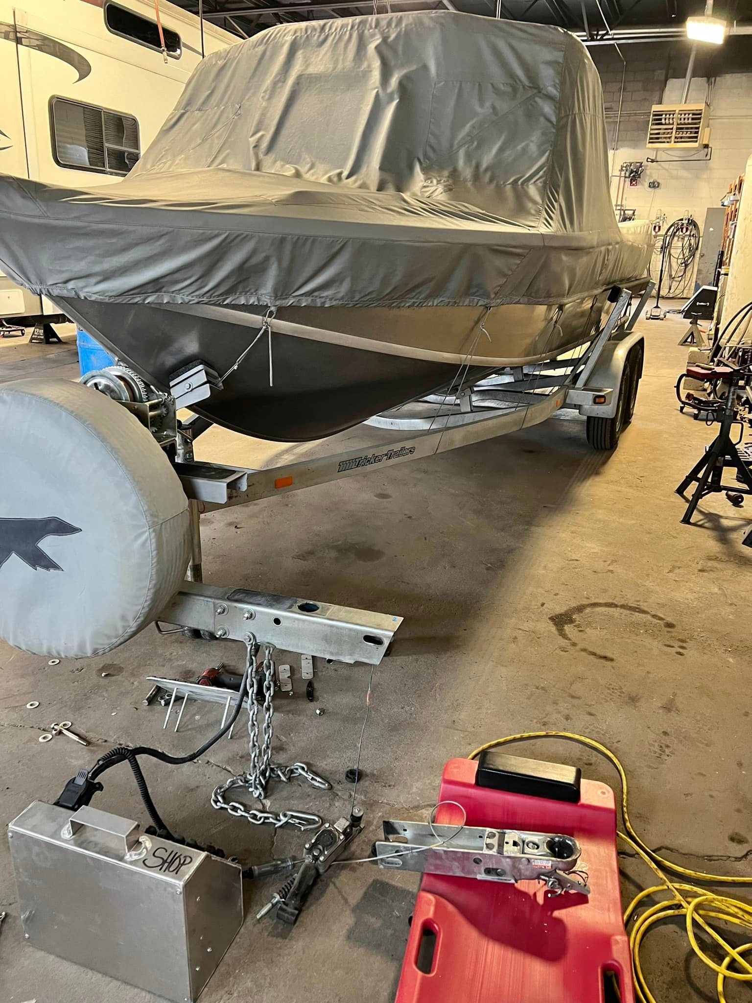 A boat is sitting on a trailer in a garage.