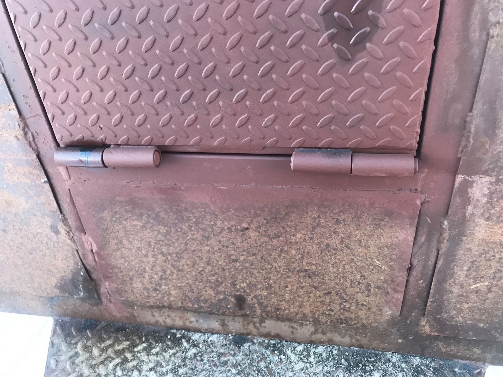 A close up of a door with a diamond plate on it