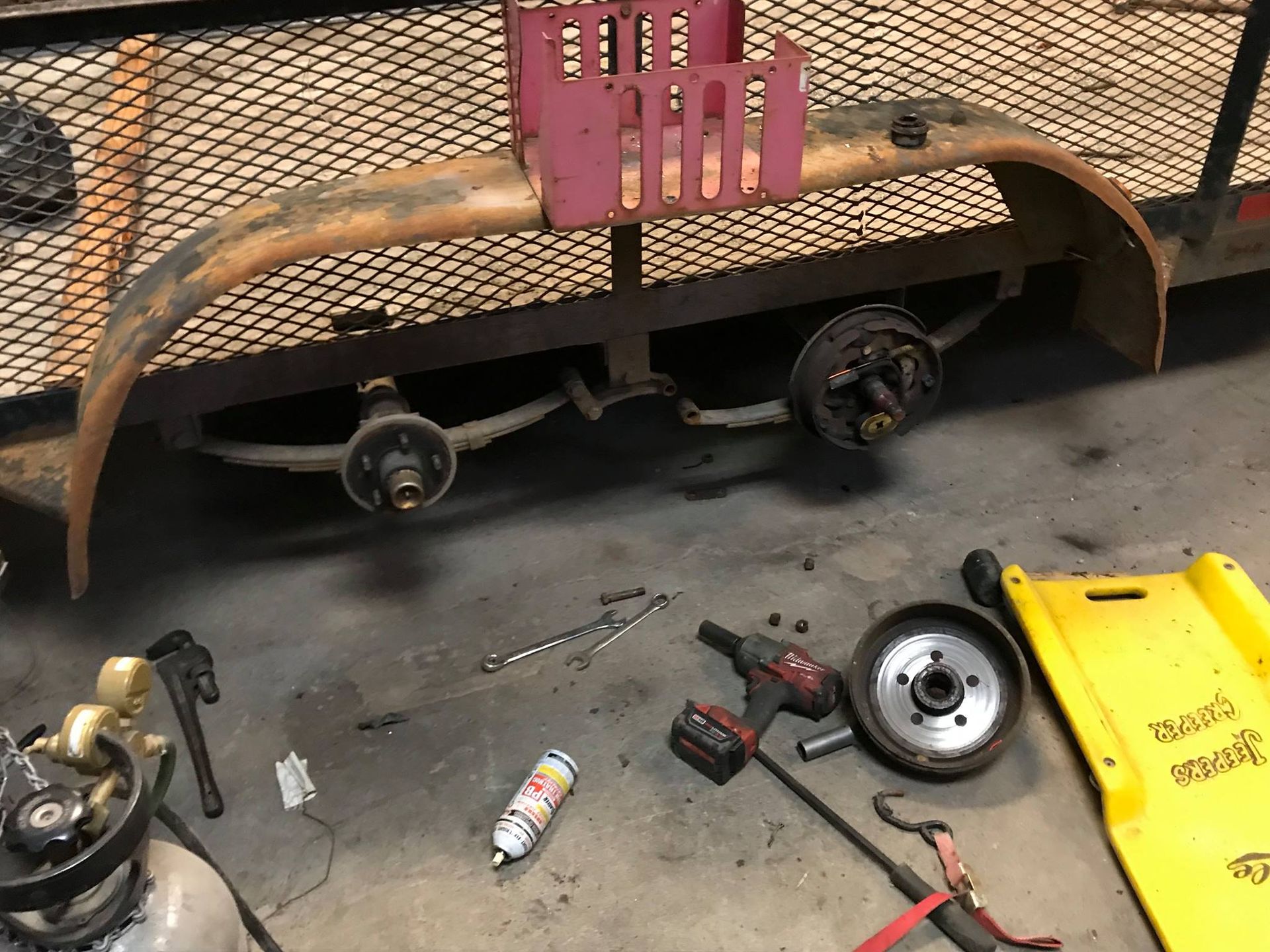 A trailer is being worked on in a garage