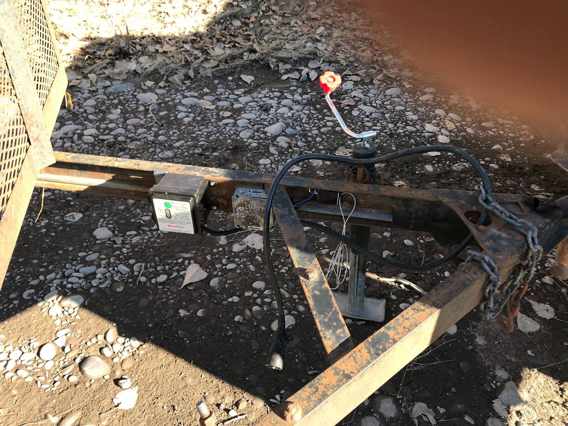 A trailer is sitting on top of a pile of rocks.
