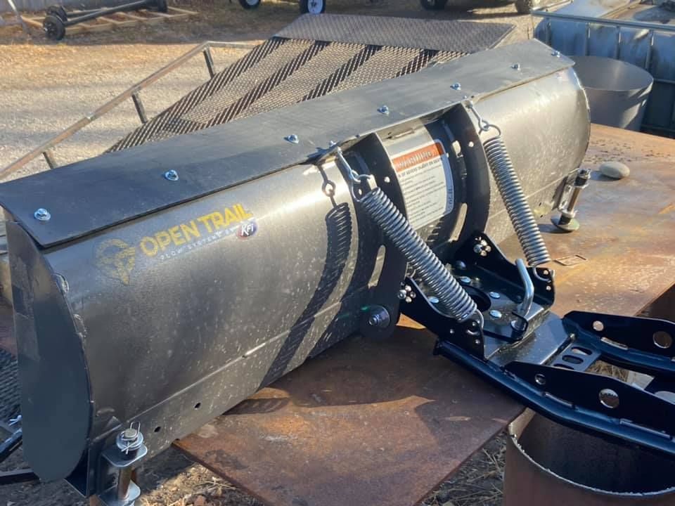 A snow plow is sitting on top of a wooden table.