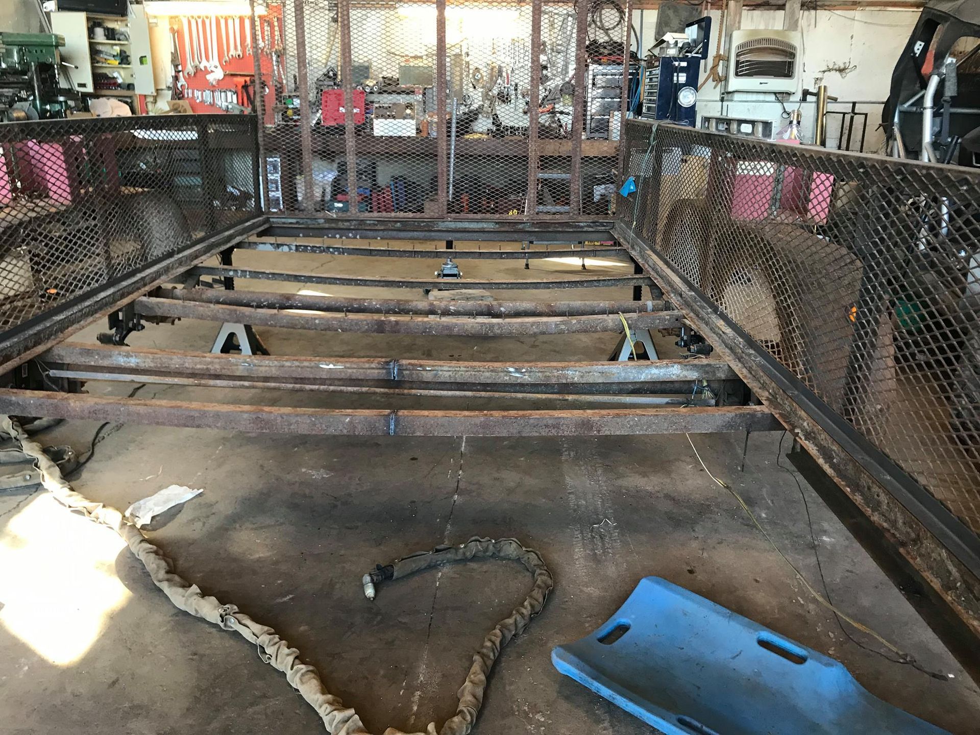 A metal structure is being built in a garage