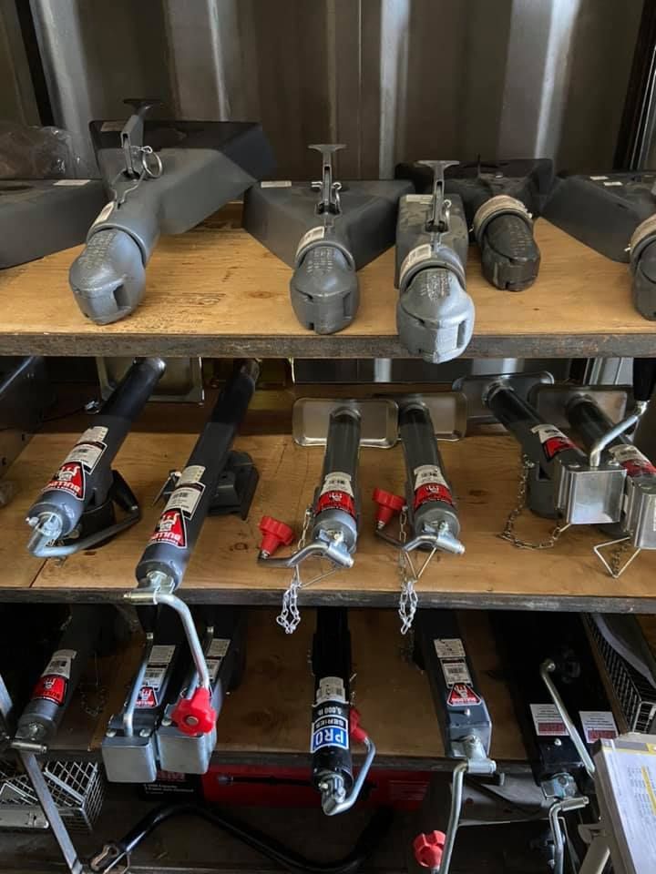 A shelf filled with a variety of trailer hitches.