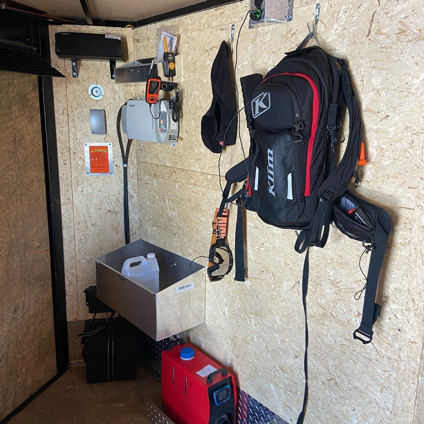 A backpack is hanging on a wall in a room