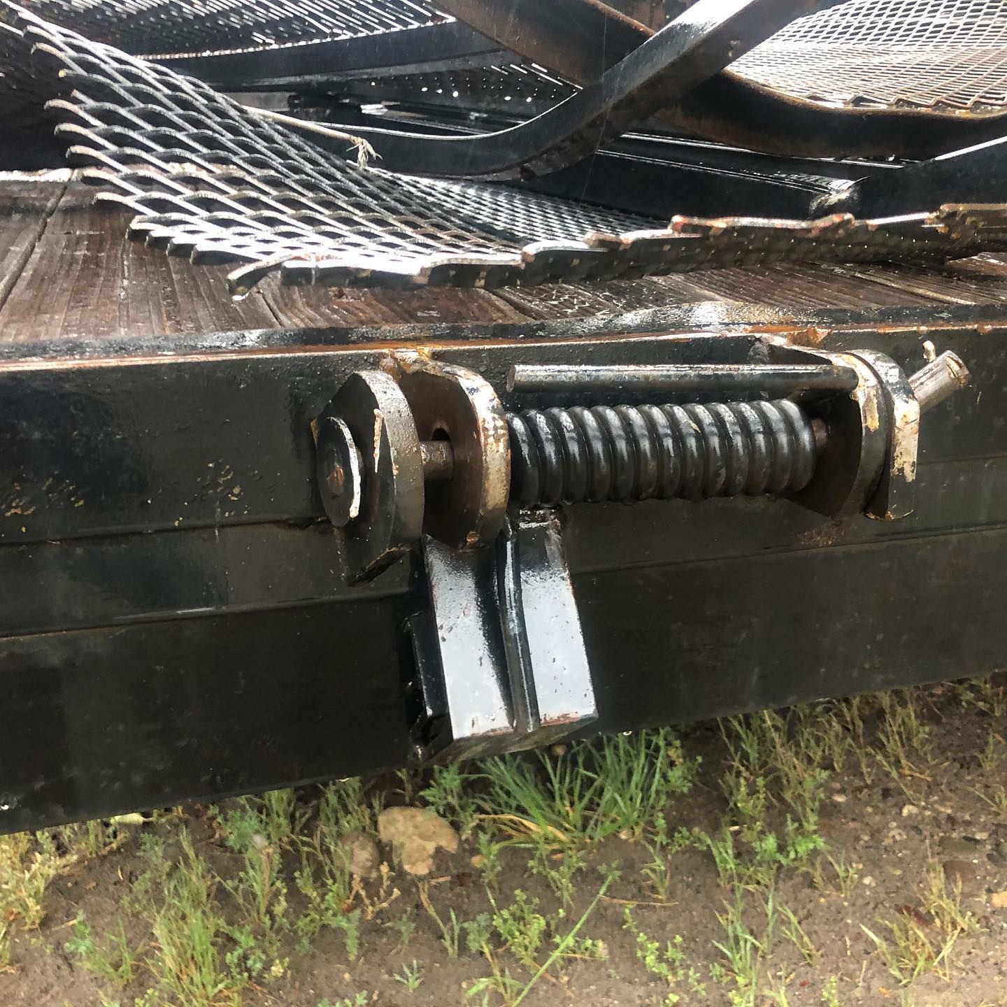 A close up of a metal object with a spring attached to it