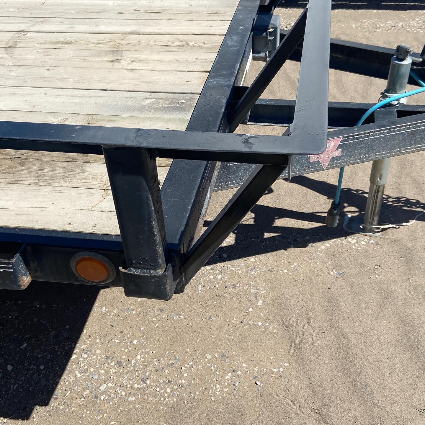 A trailer with a blue hose attached to it