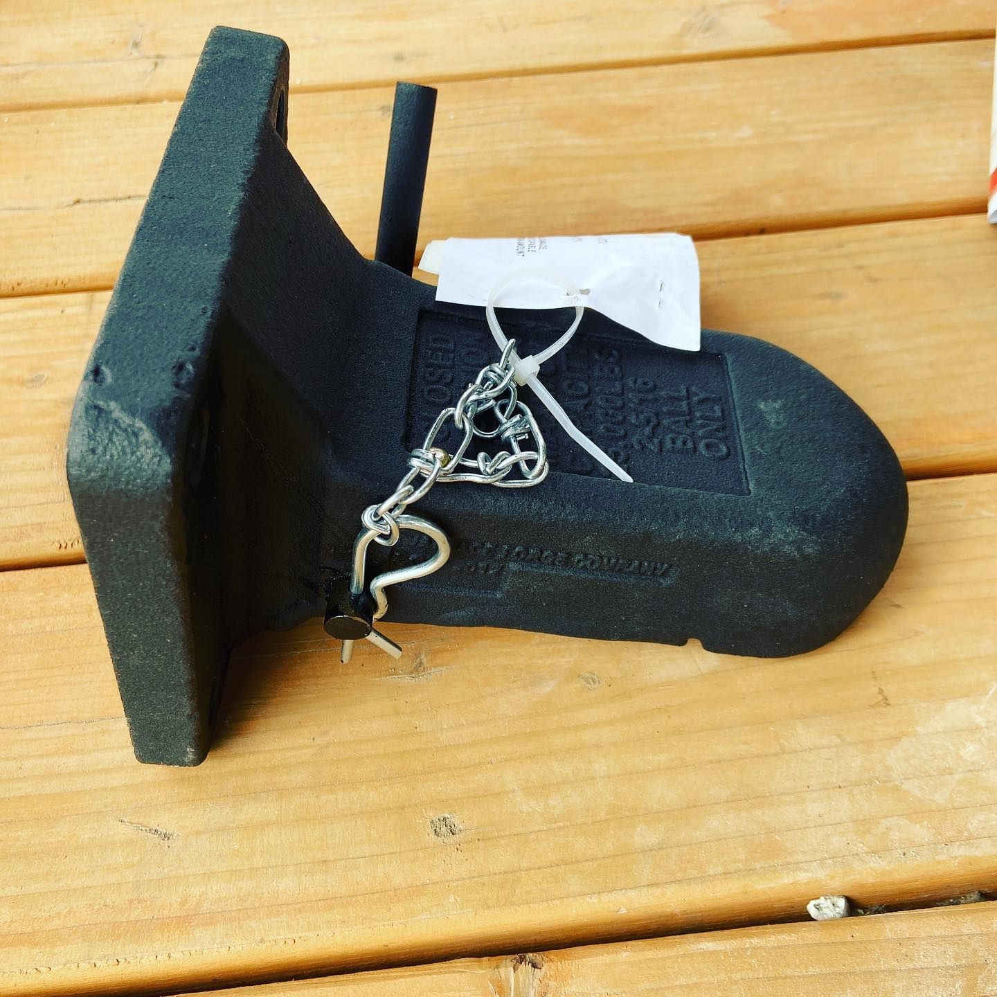 A black item with a tag on it that says ' stainless steel ' on it