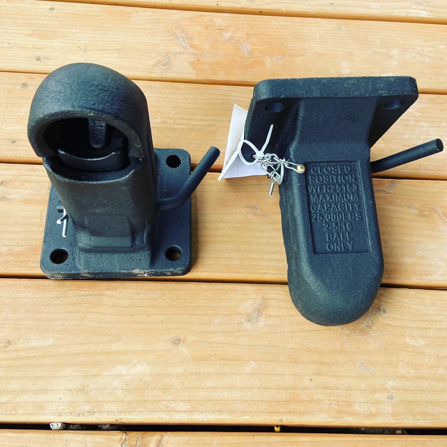 A pair of black metal pieces on a wooden table