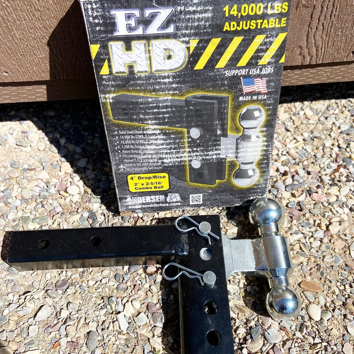 A 14000 lbs adjustable ez hd hitch is sitting on the ground