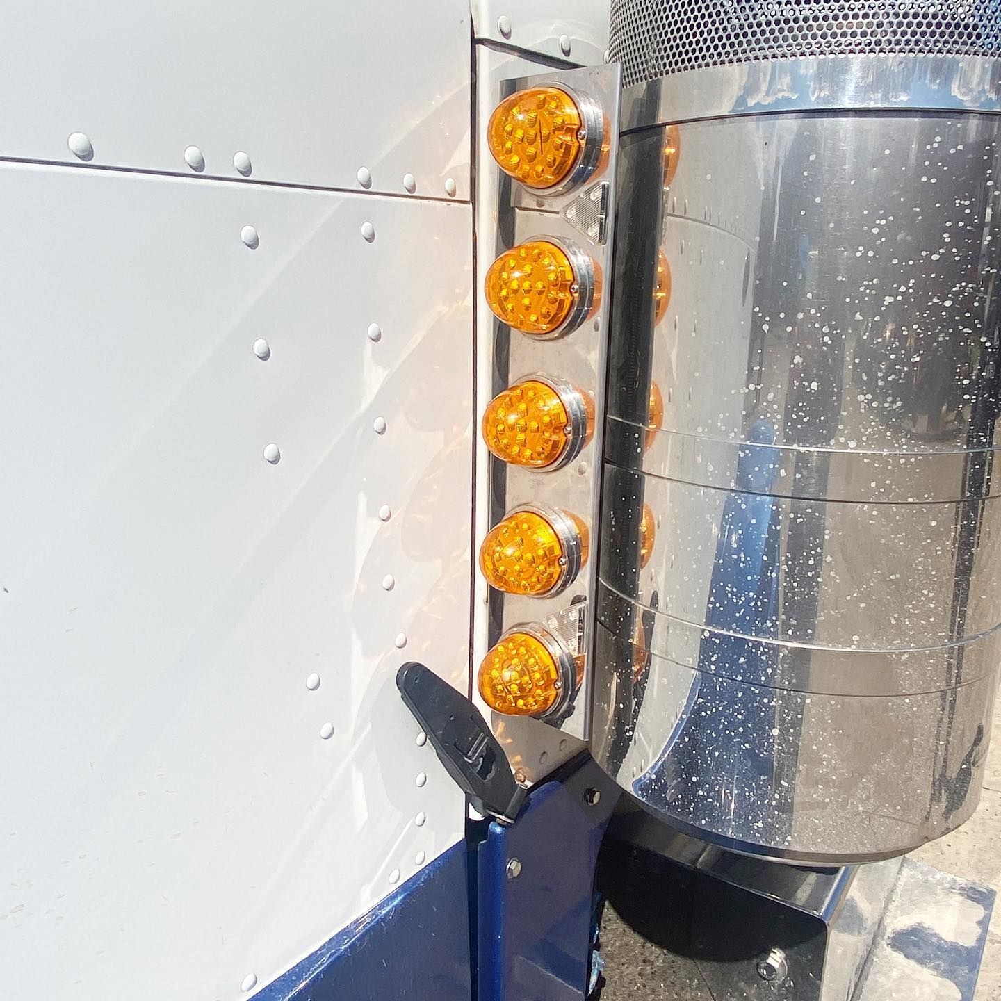 A stainless steel pipe with a bunch of lights on it