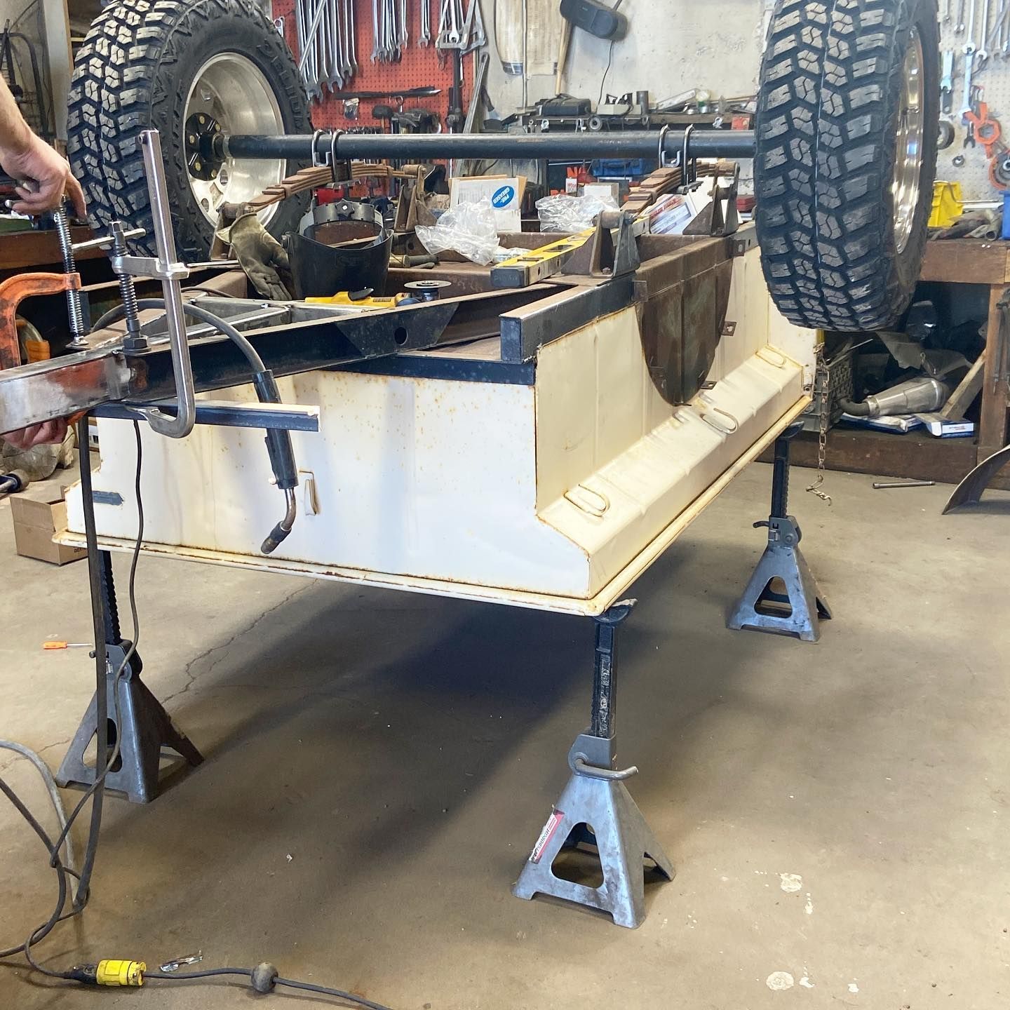 A person is working on a vehicle in a garage