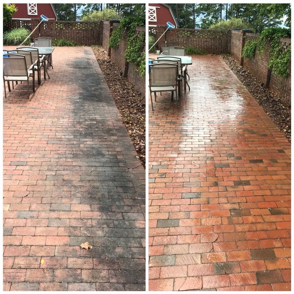 Brick patio walkway before-and-after cleaning, showing a dark dirty surface beside a wet, cleaned red brick path