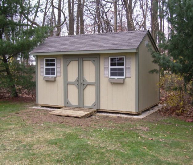 A small shed with a roof and two windows