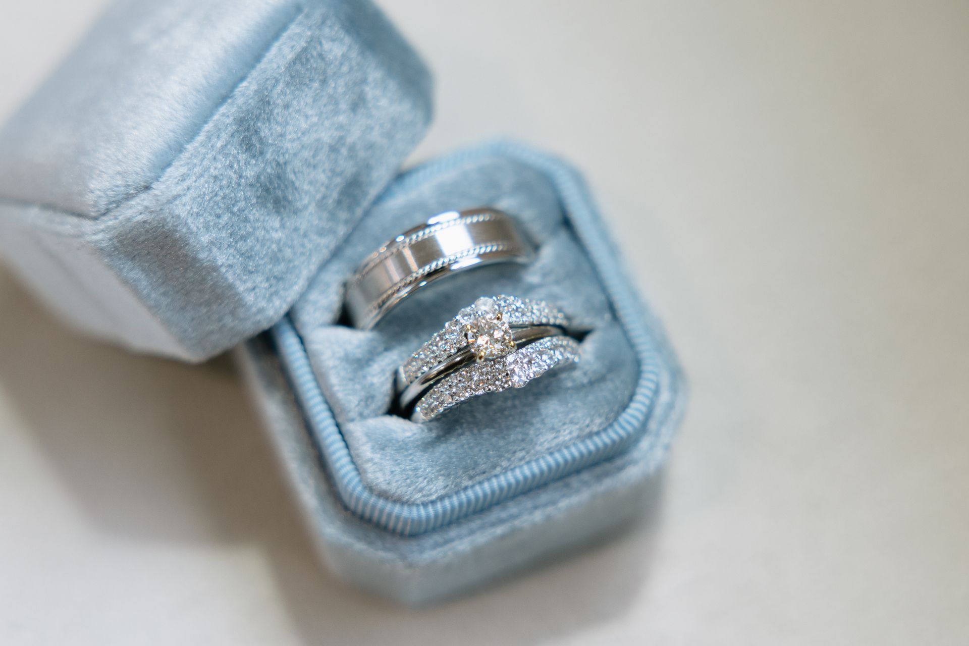 Wedding rings in a light blue velvet ring box.