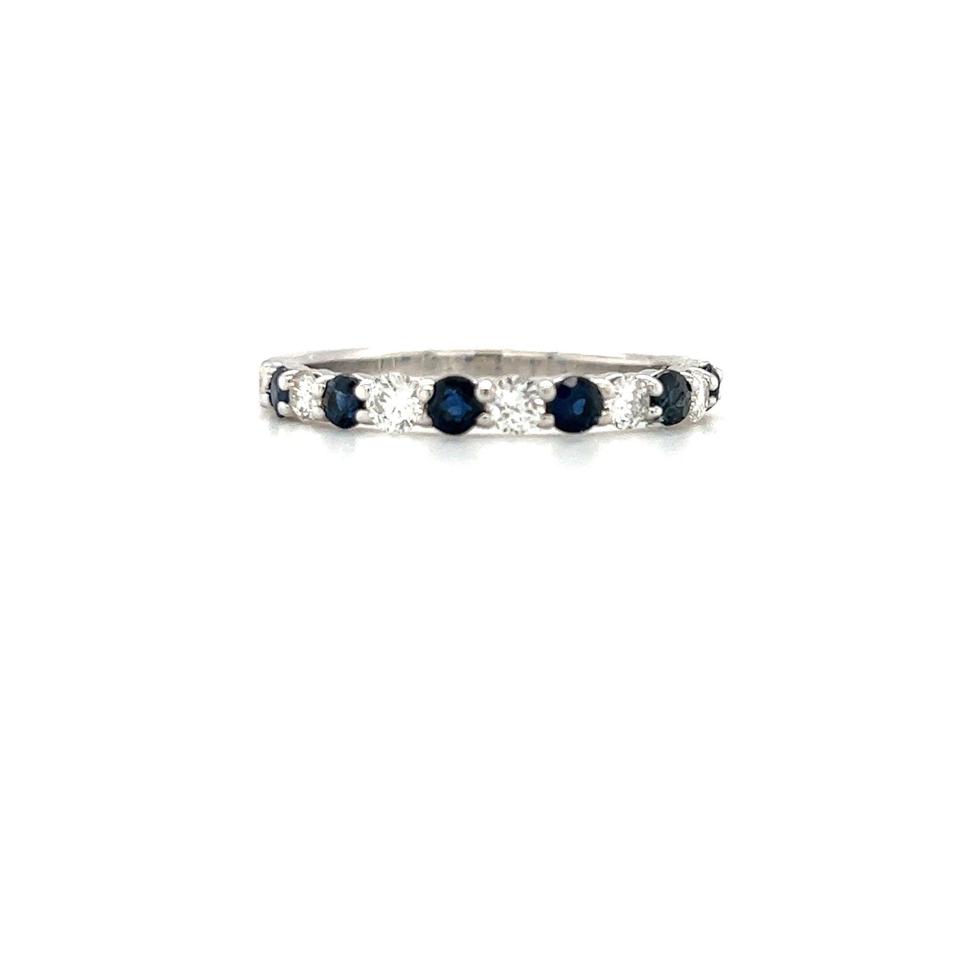 Silver band ring with alternating blue and white stones.