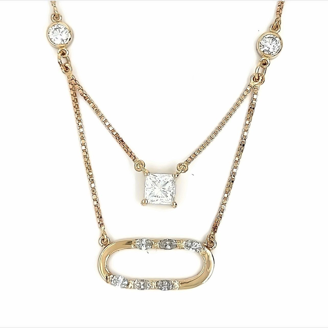 Gold necklace with diamond accents, featuring a square-cut pendant and an oval-shaped charm.