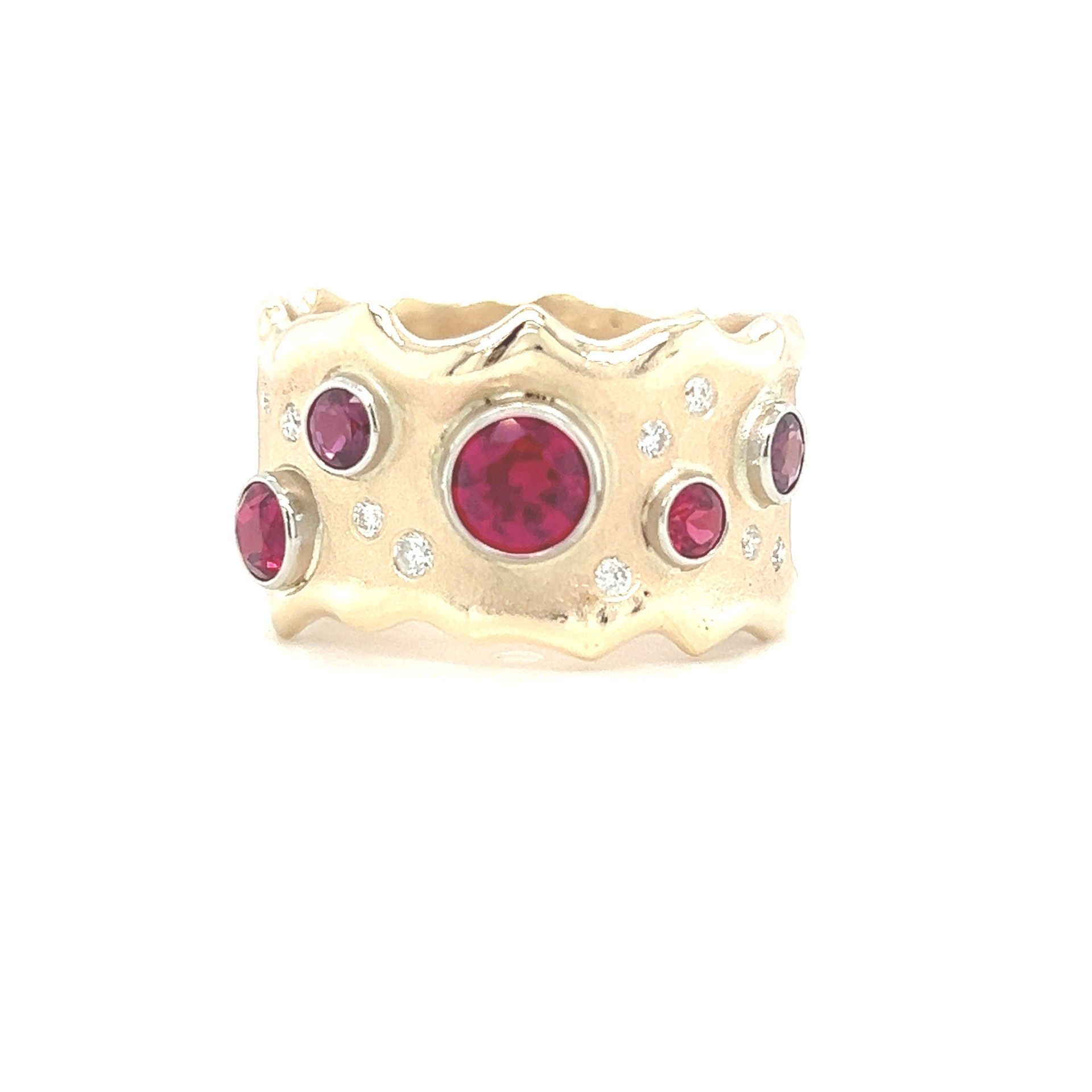 Gold ring with round red rubies and small diamonds, set in a wavy band.