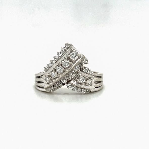 Two diamond rings with intricate, white metal bands, on a white surface.