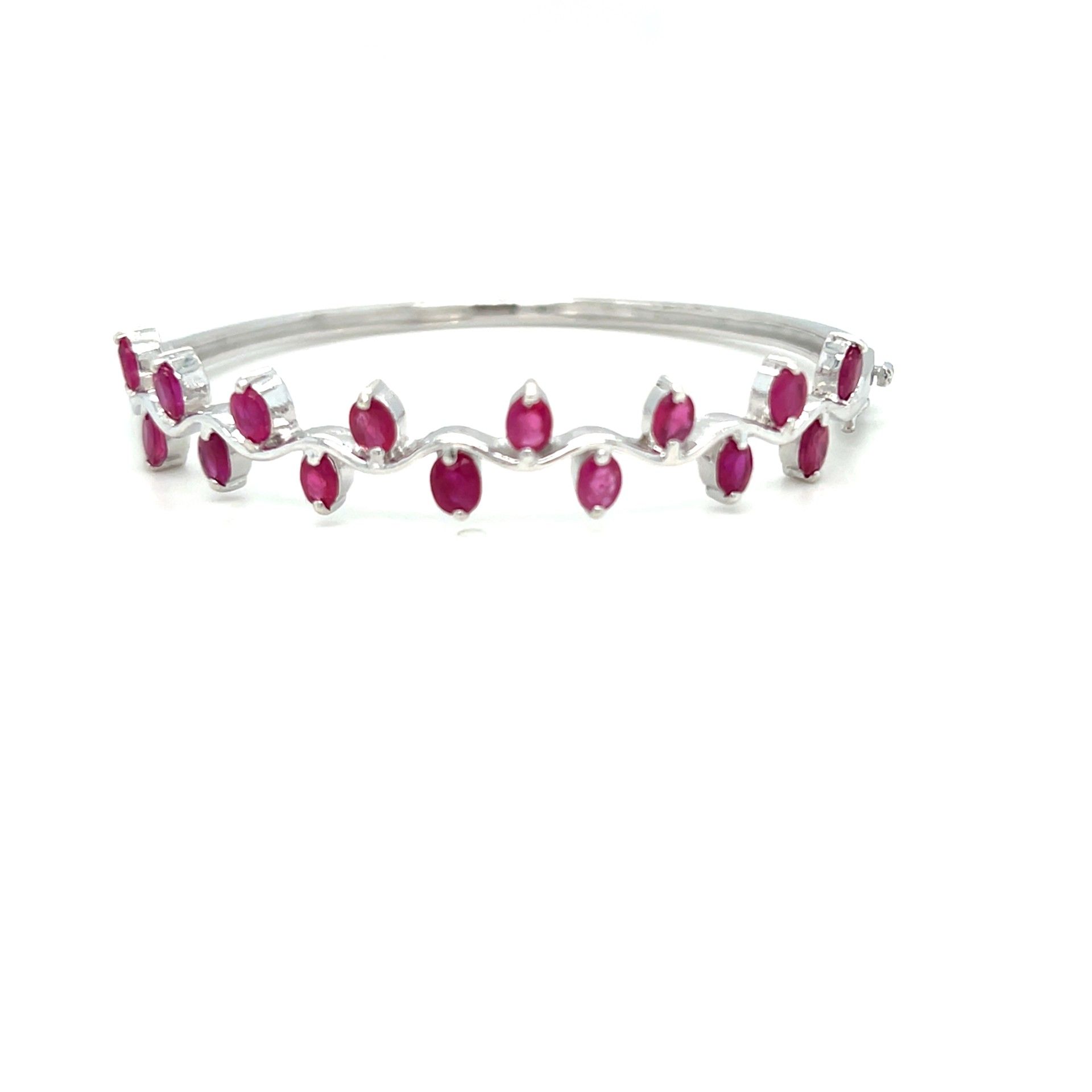 Silver bracelet with alternating oval-cut ruby stones set along the band.