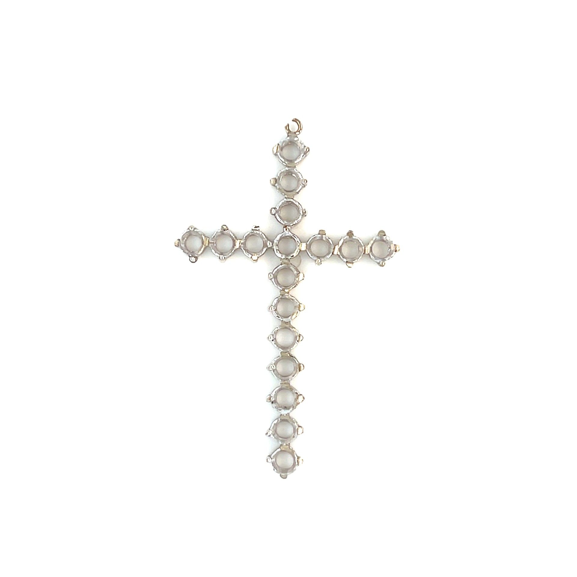 Silver cross pendant with circular settings.