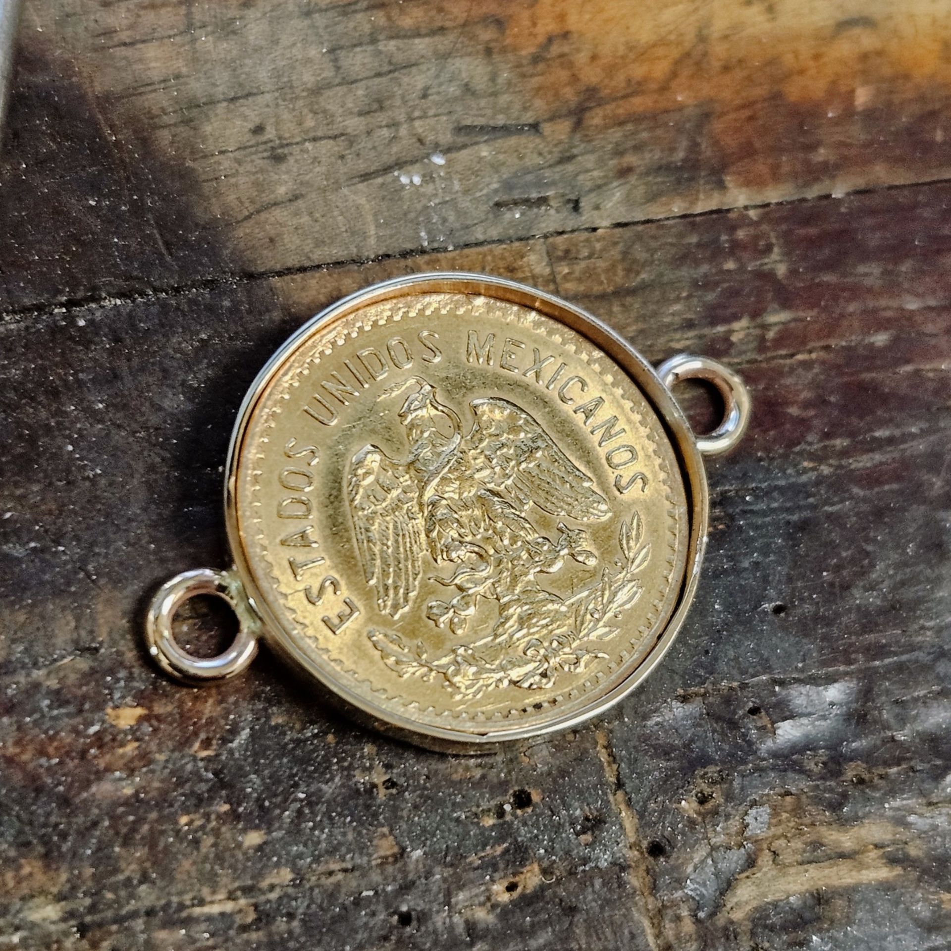 Gold coin pendant: Mexican coin set in silver bezel with two small loops for attaching to a chain.