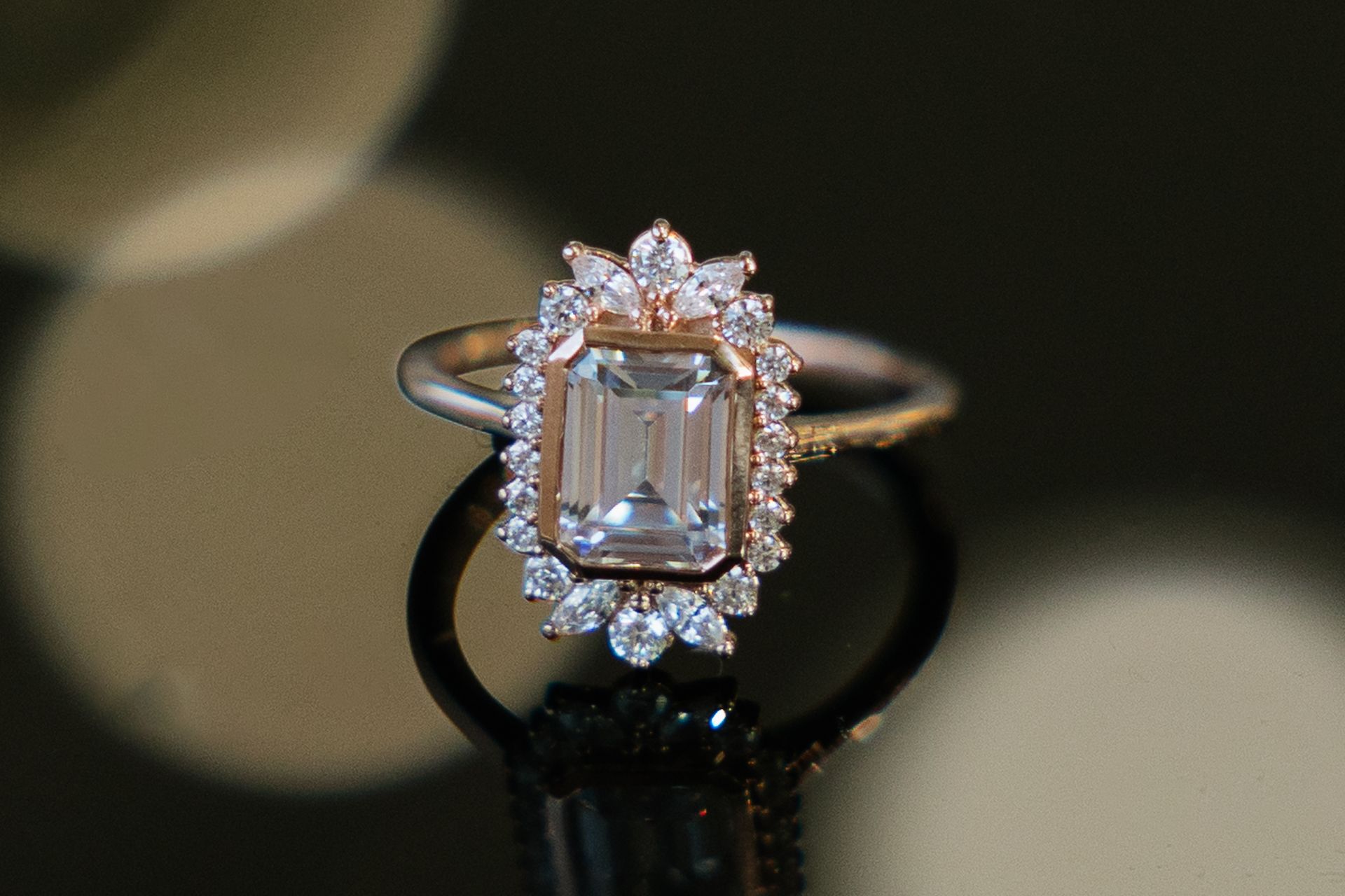 A ring with an emerald cut diamond in the center