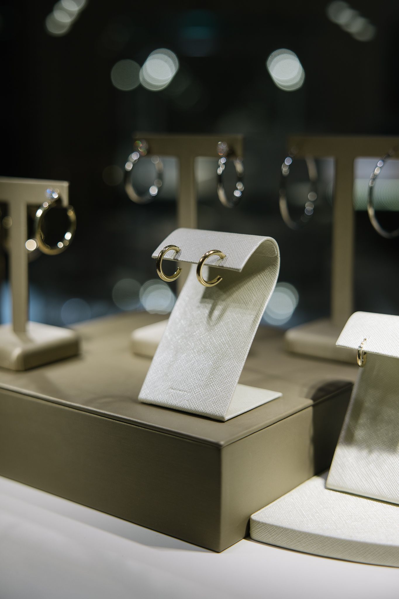 A close up of a display of earrings in a store window.